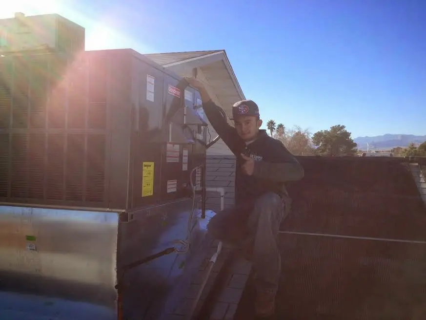 HVAC technician performing AC Tune-Up on a rooftop unit in Punxsutawney